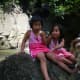 My nieces with Angus sitting on a huge rock  at Busay Waterfalls.