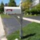 Use a pressure washer to strip off loose paint from a mailbox post
