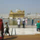 the Golden temple comes into view as one walks down the steps to the temple complex area.