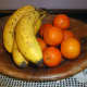 Plaited wooden with oranges and bananas
