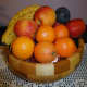 Chequered light and dark solid wood with banana, oranges, apples and plums