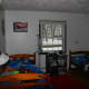 The boys' bedroom before the transformation: drab, white walls and uncoordinated bedding.