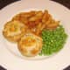 Mini haggis and clapshot puff pastry pies with homemade chips and peas