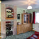 The old fireplace tiled and fitted with mirrored display shelves