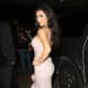Kim Kardashian wearing a pretty pink dress and high heels