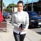 Kim Kardashian in leather pants and high heels