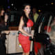 Kim Kardashian in a pretty red dress and high heels