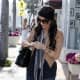 Kim Kardashian wearing ripped and torn tight jeans and high heel pumps