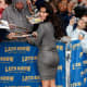 Kim Kardashian in a form fitting dress and towering high heels appearing on the Late Show