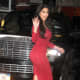 Kim Kardashian in curve hugging red dress and high heels