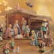 beautiful Hummel Nativity Set in soft pastels complete with wooden manger and porcelain star and angle above the manger