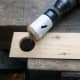 Hole cut in the test piece, to test fit the drinking horn and help determine the desired length for the stand.