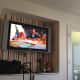 "Go" room pink striped wallpaper, TV, and closet.