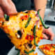 Homemade veggies pizza. We enjoy eating pizza while watching a show. I think everybody is doing that.