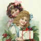 Little girls with holly and presents