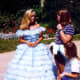 Hoop skirted young ladies roam the grounds