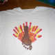 Now repeat procedure with brown paint and child's FOOT. Make sure the heel is up to make the turkey's head. The child's toes will be the turkey's feet. Wash child's foot and let paint dry.