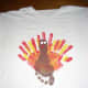 Now paint 2 white circles for the turkey's eyes. And paint a red shape for the waddle. Let paint dry.