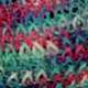 Close up of the figure eight with only one yarn done in multi-colored yarn.