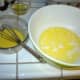 In separate bowl mix the lemon rinds, which you already grated and have ready, with the egg and yolks, and beat or whip until smooth and well mixed.