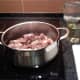 Adding the chicken gizzards to the pan