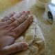 Place the dough ball on the counter. Press the dough out with your hand.