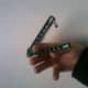 Put thumb on outside of safe handle as shown.