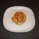 Onion rings laid on turkey bacon