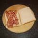 Bacon strips are laid on bread