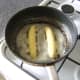 Frying banana halves in butter