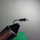 Twist the Herl around the hook shank, and then secure where it is adjacent to the hook point.