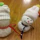 Fold top part of sock over to make a toboggan and glue small pom pom on top to close the sock. Draw on eyes, nose, mouth, and buttons with markers.