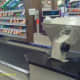 A grocery store uses a conveyor belt to move items toward the cashier for checkout.
