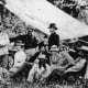 Custer, his men and their wives picknicking in South Dakota just weeks before the Battle of the Little Bighorn. I Company Commander Miles Keough (back row, center left) was one of those who would perish.