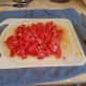 Step 12: Once your veggies have cooked, start chopping up all of your tomatoes.