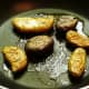 Photo of sautéing the fingerling potatoes after being briefly microwaved and smashed by hand to flatten them out.