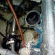 The starter is where the red, positive, cable is going to. You can't see it very well, but you can feel your way around it now.