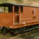 Restored to pristine condition, ex-LMS brake van in express goods bauxite livery with vacuum pipe and screw couplings for faster running