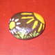 Flower, Project No. 4. 2012. I left this rock brown. I usually paint the entire surface of the rock, but this one was pretty as it was. Then I painted the sun, the flower, and some grass. April 2012.