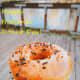 A glazed donut with sprinkles and a hot coffee—the perfect pairing!
