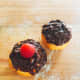 Donuts topped with chocolate, nuts, and raspberry
