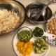 Ingredients assembled: cabbage, dressing, toasted noodles, and almonds, green onions, avocado, mango, and edamame