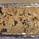 Place broken ramen and sliced almonds on a baking sheet.