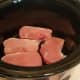 Lay your thawed pork chops in the bottom of your crockpot.