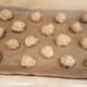 Roll biscuits sized balls together and lay them out evenly on your cookie sheet. We smashed them down a bit.