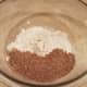 Start by adding half of your flour and your flaxseed to a large mixing bowl.