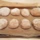 Roll each into a dome shape and place on your parchment paper.