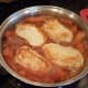 Add your pork chops back into the mix and slide them into the bottom.
