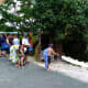 Tourists near huts where locals are braiding hair