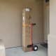 We used this red hand truck and a simple tie down to wheel the approximately 80 pound box to our second floor bedroom.
